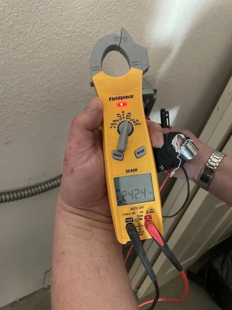 Voltage testing with clamp meter during Outlet Installation in Barstow